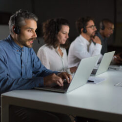 Focused call center operators during working process. Confident client support team at workplace. Call center concept