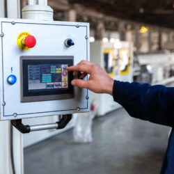 worker uses control panel in factory